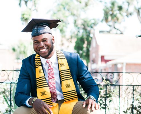 College student posing for picture after graduation.