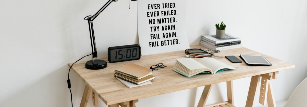 Sign on desk reminding us to overcome failure, by failing better next time