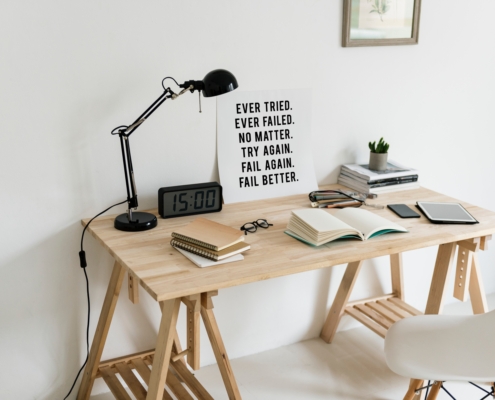 Sign on desk reminding us to overcome failure, by failing better next time