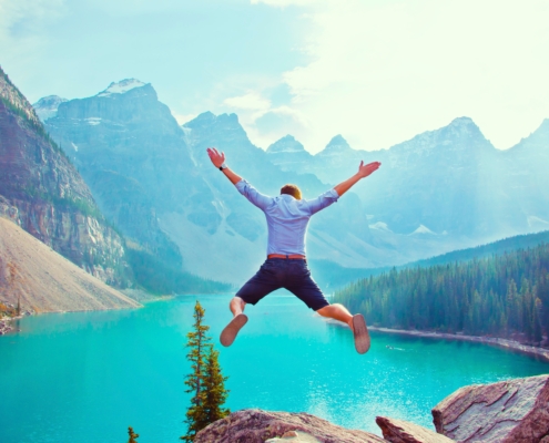 man jumping off cliff, describing exploration, discovery, joy